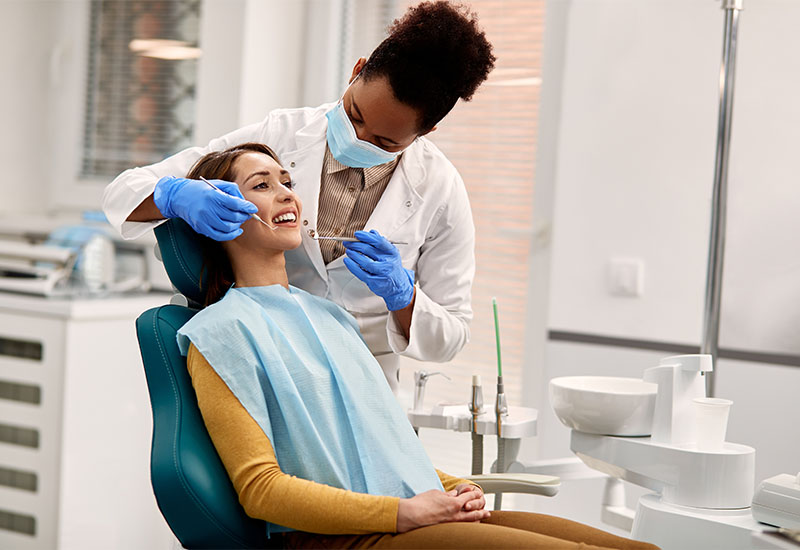 Detail of a dental treatment chair, overhead light and equipment in an operatory