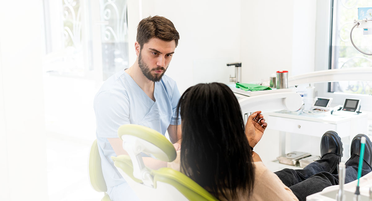 A dentist talking a patient through treatment options during a consultation