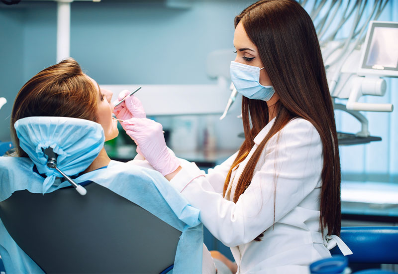 A clinician carrying out a cleaning during a dental appointment